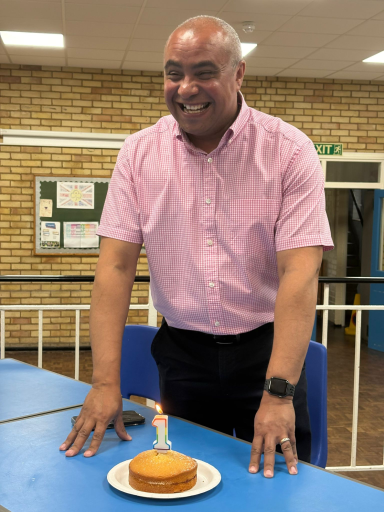 Celebrating One Year as Southend West and Leigh's MP (July 2025) David smiling with a cake that has a number 1 candle