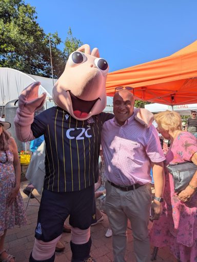 With Sammy the Shrimp! David smiling with a Shrimp mascot