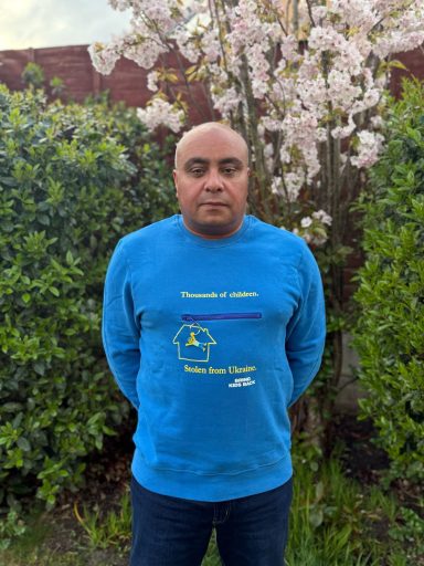 Supporting the Bring Back Kids UA campaign David standing in a garden wearing a jumper supporting the Bring Back Kids UA campaign