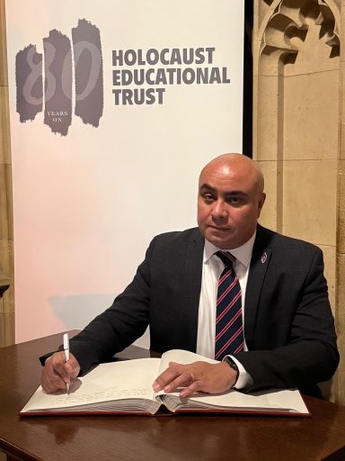 Marking Holocaust Memorial Day 2025 David signing the the Holocaust Educational Trust's Book of Commitment